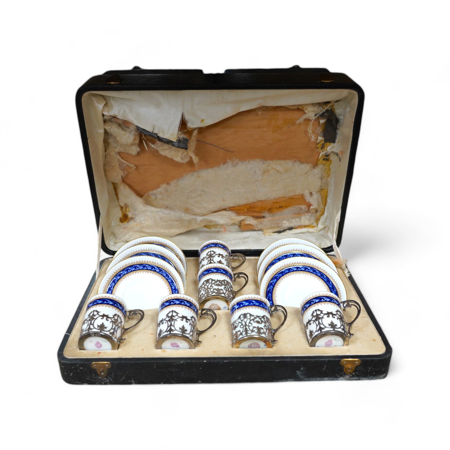 A cased Worcester coffee set with silver coffee can holders, saucers 11.5cm in diameter. Condition - fair, some cracks and crazing